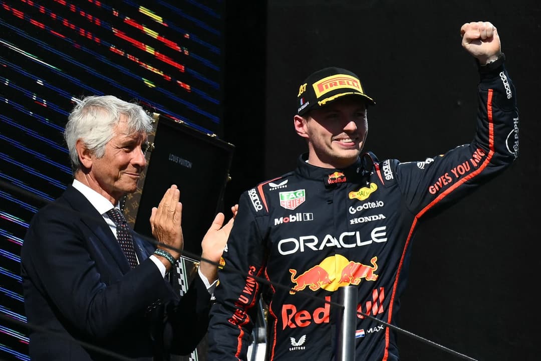 Red Bull Racing's Dutch driver Max Verstappen celebrates on the podium after winning the 2025 Emilia Romagna Formula One Grand Prix at the Imola autodrome in Imola, on May 18, 2025. (Photo by Marco BERTORELLO / AFP)