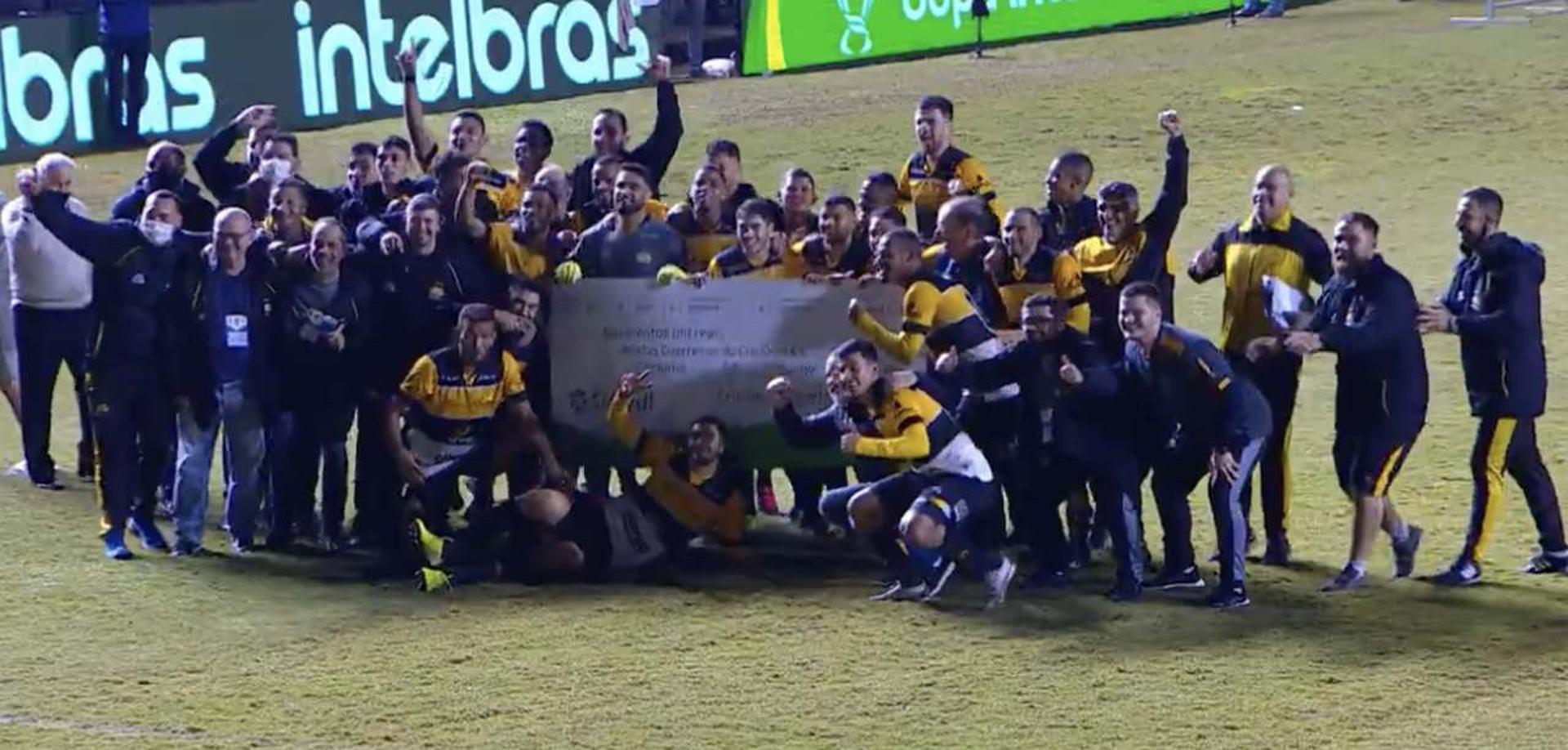 Jogadores do Criciúma comemoram com cheque após classificação