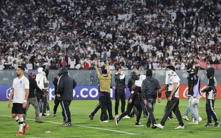Torcedores invadem o campo em Colo-Colo x Fortaleza. (foto: Javier TORRES / AFP)