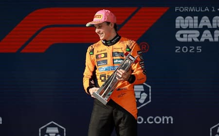 MIAMI, FLORIDA - MAY 04: Race winner Oscar Piastri of Australia and McLaren Second placed Lando Norris of Great Britain and McLaren and Third placed George Russell of Great Britain and Mercedes AMG Petronas F1 Team on the podium during the F1 Grand Prix of Miami at Miami International Autodrome on May 04, 2025 in Miami, Florida. Hector Vivas/Getty Images/AFP (Photo by Hector Vivas / GETTY IMAGES NORTH AMERICA / Getty Images via AFP)