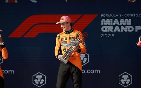 MIAMI, FLORIDA - MAY 04: Race winner Oscar Piastri of Australia and McLaren Second placed Lando Norris of Great Britain and McLaren and Third placed George Russell of Great Britain and Mercedes AMG Petronas F1 Team on the podium during the F1 Grand Prix of Miami at Miami International Autodrome on May 04, 2025 in Miami, Florida. Hector Vivas/Getty Images/AFP (Photo by Hector Vivas / GETTY IMAGES NORTH AMERICA / Getty Images via AFP)
