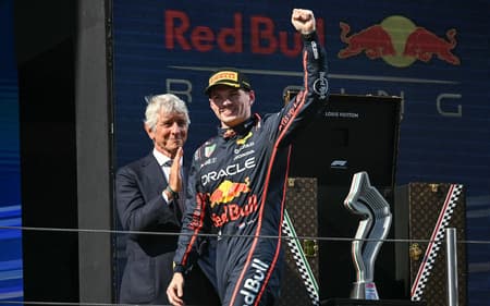 Red Bull Racing's Dutch driver Max Verstappen celebrates on the podium after winning the 2025 Emilia Romagna Formula One Grand Prix at the Imola autodrome in Imola, on May 18, 2025. (Photo by Andrej ISAKOVIC / AFP)