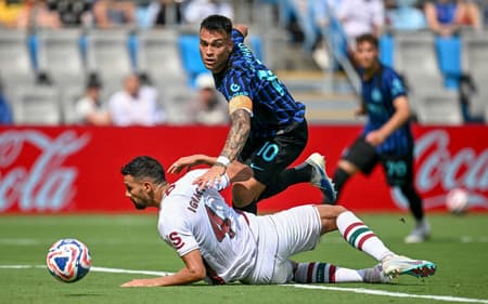 Fluminense's Brazilian defender #04 Ignacio (L) tackles Inter Milan's Argentine forward #10 Lautaro Martinez (C) preventing a goal scoring opportunity during the FIFA Club World Cup 2025 round of 16 football match between Italy's Inter Milan and Brazil's Fluminense at the Bank of America Stadium in Charlotte on June 30, 2025. (Photo by Paul ELLIS / AFP)