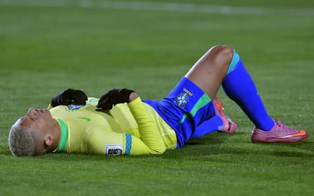 Richarlison caído durante o jogo entre Brasil e Bolívia nas Eliminatórias (Foto: Daniel MIRANDA / AFP)