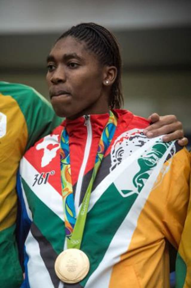 Caster Semenya em sua chegada na África do Sul, com casaco da 361° (Foto: Mujahid Sadodien/AFP)