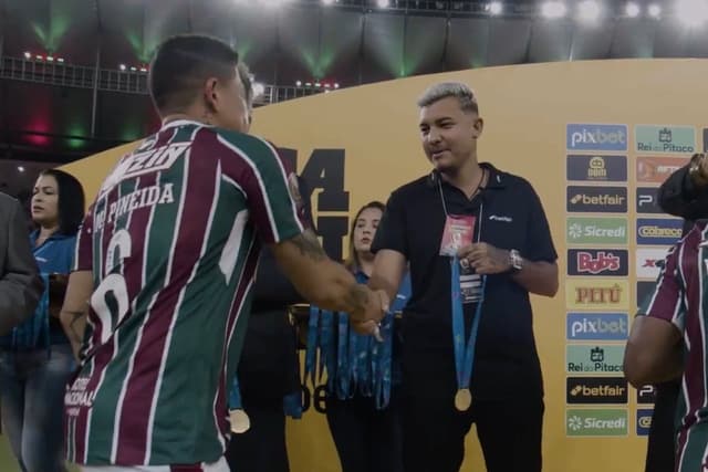 Torcedor do Fluminense entregando medalha na final do Campeonato Carioca