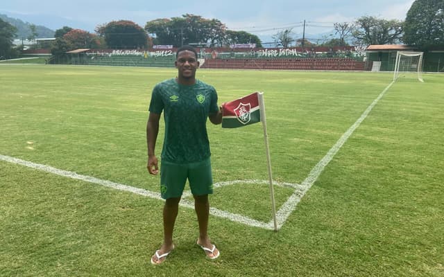 Fabinho-posa-ao-lado-do-escudo-do-Fluminense-no-Estadio-Marcelo-Vieira-em-Xerem-scaled-aspect-ratio-512-320