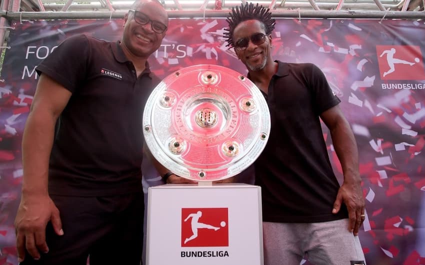 Paulo Sergio e Zé Roberto ao lado da taça da Bundesliga, na Bundesliga Experience