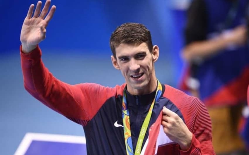 Michael Phelps com algumas de suas tantas medalhas olímpicas (Foto: AFP)