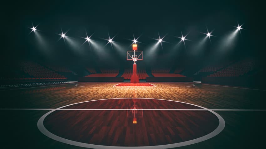 Interior view of an illuminated basketball stadium for a game