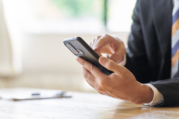 Hands of a businessman using a smartphone