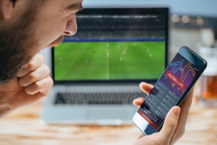 Man celebrating victory after making bets at bookmaker website