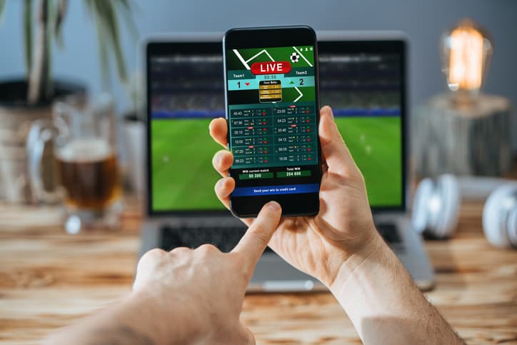 Man celebrating victory after making bets at bookmaker website