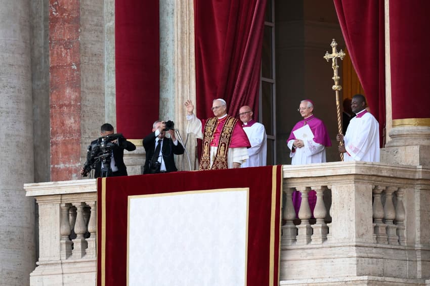 This photo taken and handout on May 7, 2025 by The Vatican Media shows Newly elected Pope Leo XIV, Robert Prevost addressing the crowd from the main central loggia balcony of the St Peter's Basilica for the first time, after the cardinals ended the conclave, in The Vatican. (Photo by Handout / VATICAN MEDIA / AFP) / RESTRICTED TO EDITORIAL USE - MANDATORY CREDIT "AFP PHOTO / VATICAN MEDIA" - NO MARKETING - NO ADVERTISING CAMPAIGNS - DISTRIBUTED AS A SERVICE TO CLIENTS