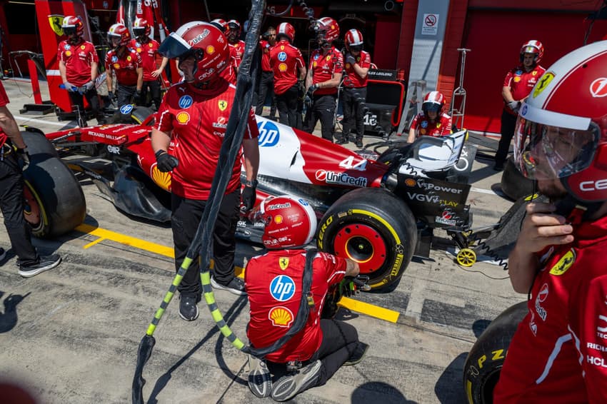 Ferrari's mechanics practice a pit-stop ahead of the 2025 Emilia Romagna Formula One Grand Prix at the Imola autodrome in Imola, on May 15, 2025. (Photo by Andrej ISAKOVIC / AFP)
