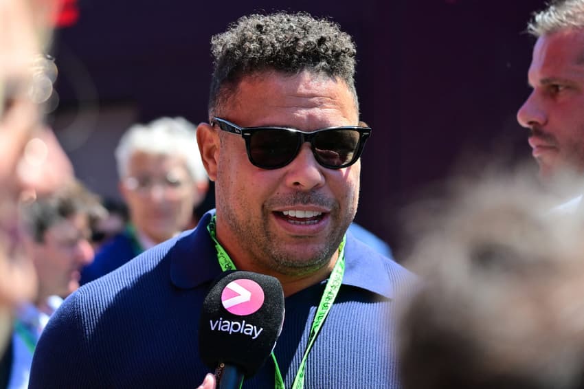 Brazilian football legend Ronaldo Nazario talks to the press as he arrives to attend the 2025 Emilia Romagna Formula One Grand Prix at the Imola autodrome in Imola, on May 18, 2025. (Photo by Andrej ISAKOVIC / AFP)
