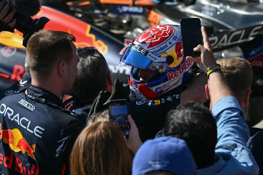 Red Bull Racing's Dutch driver Max Verstappen celebrates with team members after winning the 2025 Emilia Romagna Formula One Grand Prix at the Imola autodrome in Imola, on May 18, 2025. (Photo by Andrej ISAKOVIC / AFP)