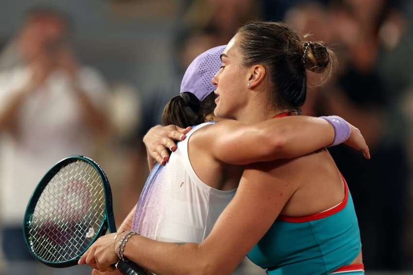 Belarus' Aryna Sabalenka (R) comforts Poland's Iga Swiatek after defeating her in their women's singles semi-final match on day 12 of the French Open tennis tournament on Court Philippe-Chatrier at the Roland-Garros Complex in Paris on June 5, 2025. (Photo by Alain JOCARD / AFP)