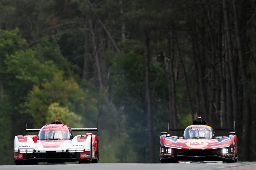 Porsche Penske Motorsport's Brazillian driver #4 Felipe Nasr (L) steers his hypercar next to Ferrari AF Corse's British driver #51 James Calado (R) during the third free practice for the 2025 Le Mans 24 hour endurance race at the Le Mans circuit, in northwestern France, on June 12, 2025. (Photo by JEAN-FRANCOIS MONIER / AFP)
