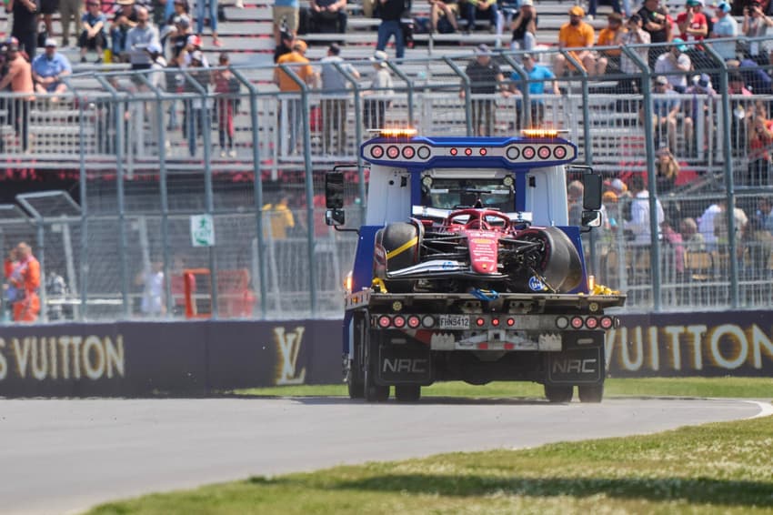 Ferrari's Monegasque driver Charles Leclerc's car is taken to the pits after he crashed during the first practice session for the 2025 Formula 1 Grand Prix du Canada at Circuit Gilles-Villeneuve in Montreal, Canada, on June 13, 2025. (Photo by Geoff Robins / AFP)