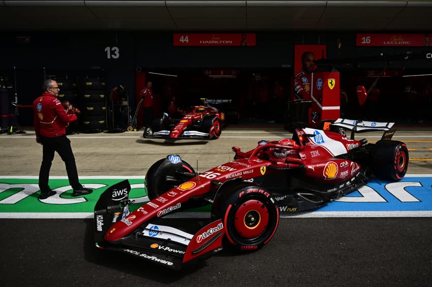Ferrari's British driver Lewis Hamilton (L) and Ferrari's Monegasque driver Charles Leclerc (R) leave the garage during the qualifying session ahead of the Formula One British Grand Prix at the Silverstone motor racing circuit in Silverstone, central England, on July 5, 2025. (Photo by Ben STANSALL / POOL / AFP)