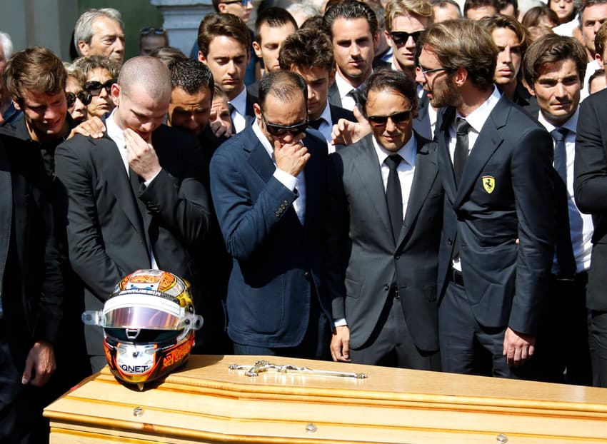 Formula 1 drivers, French Jean-Eric Vergne (R), Venezuela's Pastor Maldonado (C-L) and Brazilian Felipe Massa (C) stand with other drivers, friends and relatives in front of late French Formula 1 driver Jules Bianchi's coffin after his funeral ceremony outside Cathedrale Sainte Reparate in Nice on July 21, 2015, southeastern France. Nine months after his horror crash during the Japan Grand Prix in Suzuka, Bianchi died on July 17, 2015 in a hospital of his hometown of Nice from head injuries sustained in the October 5 accident. AFP PHOTO / VALERY HACHE