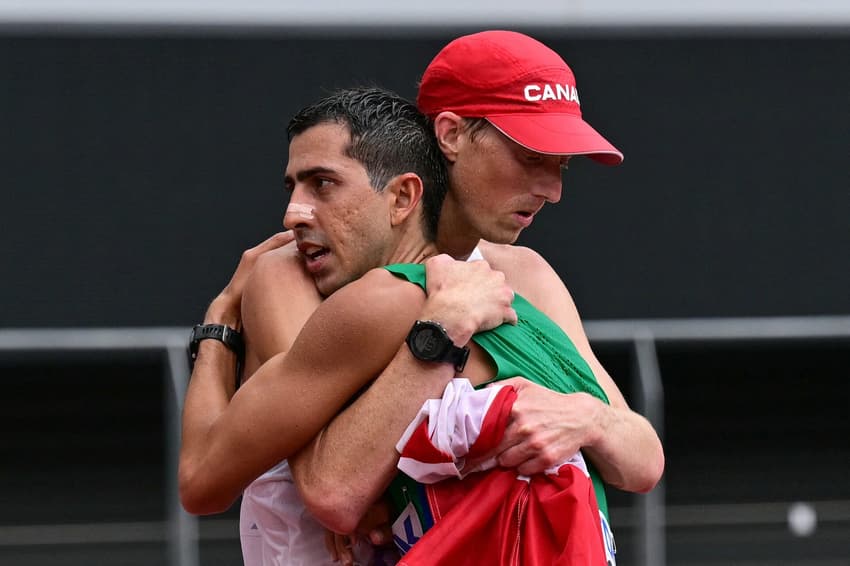 Silver medallist Brazil's athlete Caio Bonfim celebrates after crossing the finish line of the men's 35km race walk final during the World Athletics Championships in Tokyo on September 13, 2025. (Photo by Ben STANSALL / AFP)