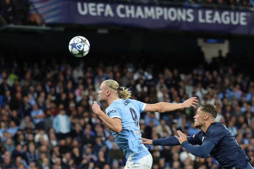 O atacante Erling Haaland marca de cabeça no duelo contra o Napoli, pela Champions League (Foto: Darren Staples / AFP)