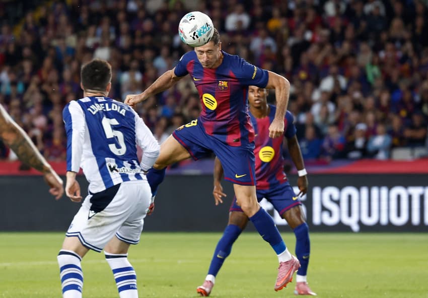 Barcelona's Polish forward #09 Robert Lewandowski (C) scores his team's second goal during the Spanish league football match between FC Barcelona and Real Sociedad at the Estadi Olimpic Lluis Companys in Barcelona on September 28, 2025. (Photo by Josep LAGO / AFP)