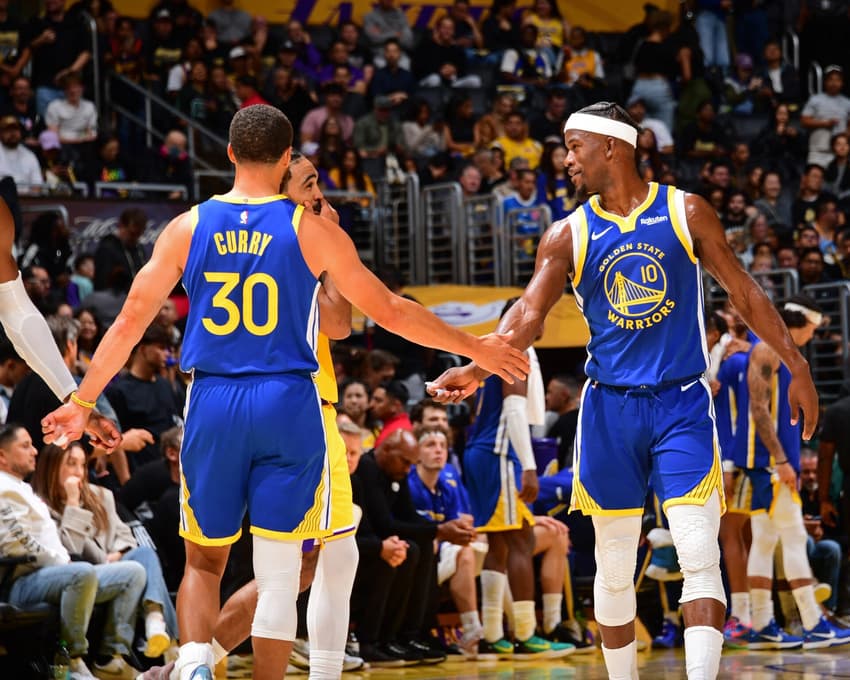 LOS ANGELES, CA - OCTOBER 21: Stephen Curry #30 high fives Jimmy Butler III #10 of the Golden State Warriors during the game against the Los Angeles Lakers on October 21, 2025 at Crypto.Com Arena in Los Angeles, California. NOTE TO USER: User expressly acknowledges and agrees that, by downloading and/or using this Photograph, user is consenting to the terms and conditions of the Getty Images License Agreement. Mandatory Copyright Notice: Copyright 2025 NBAE   Adam Pantozzi/NBAE via Getty Images/AFP (Photo by Adam Pantozzi / NBAE / Getty Images / Getty Images via AFP)