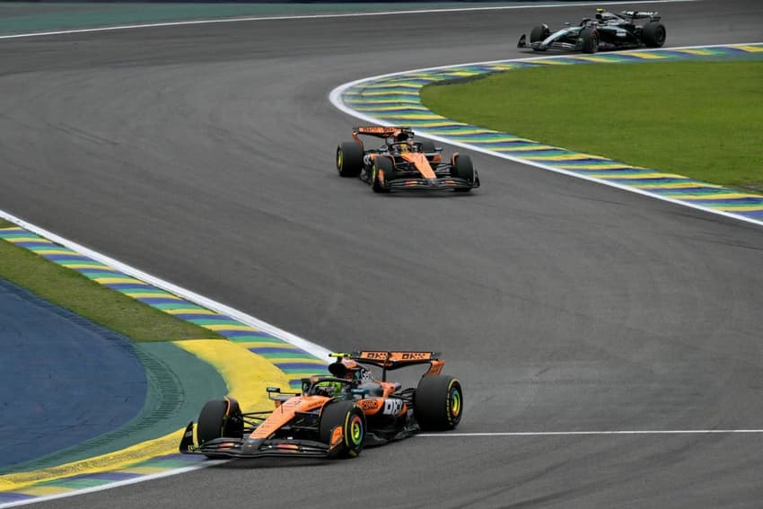 McLaren's British driver Lando Norris (Bottom) races in the lead ahead of McLaren's Australian driver Oscar Piastri and Mercedes' Italian driver Kimi Antonelli during the Sao Paulo Formula One Grand Prix at the Jose Carlos Pace racetrack, aka Interlagos, in Sao Paulo, Brazil on November 9, 2025. (Photo by Nelson ALMEIDA / AFP)