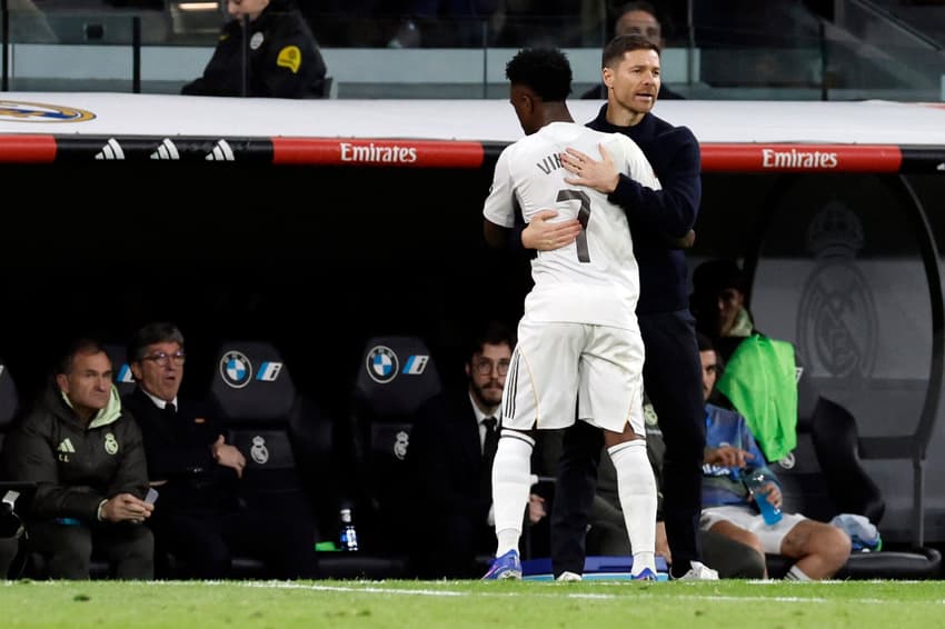 Xabi Alons e Vini Jr se abraçam após substituição no jogo entre Real Madrid x Sevilla (Foto: Oscar DEL POZO / AFP)