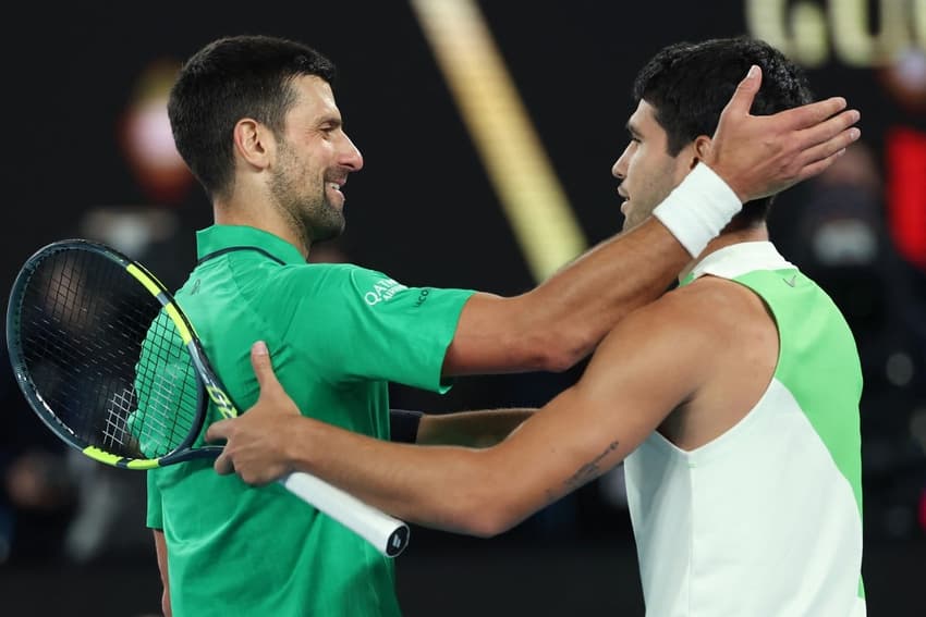 O sérvio Novak Djokovic cumprimenta o espanhol Carlos Alcaraz após a vitória na final do Australian Open (Foto: Martin KEEP / AFP)