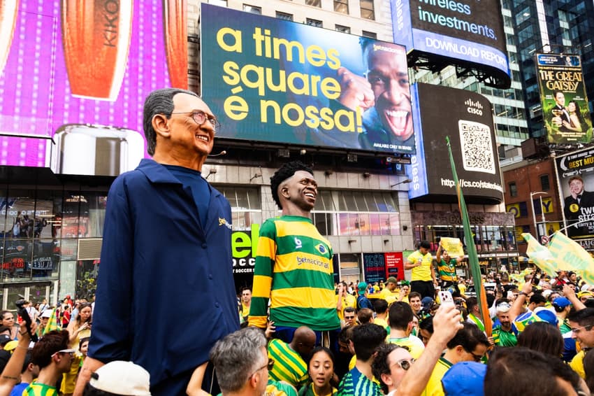 No meio da multidão, bonecos de Galvão e Vini Jr na Times Square
