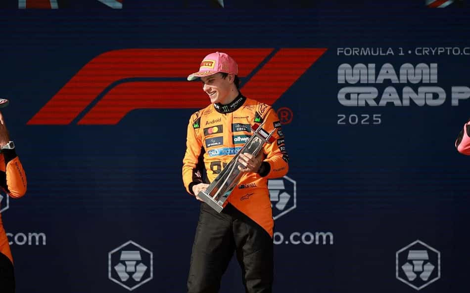 MIAMI, FLORIDA - MAY 04: Race winner Oscar Piastri of Australia and McLaren Second placed Lando Norris of Great Britain and McLaren and Third placed George Russell of Great Britain and Mercedes AMG Petronas F1 Team on the podium during the F1 Grand Prix of Miami at Miami International Autodrome on May 04, 2025 in Miami, Florida. Hector Vivas/Getty Images/AFP (Photo by Hector Vivas / GETTY IMAGES NORTH AMERICA / Getty Images via AFP)