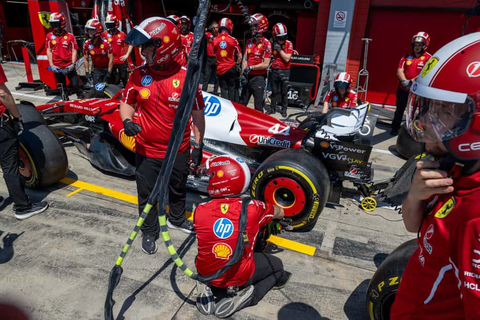 Ferrari's mechanics practice a pit-stop ahead of the 2025 Emilia Romagna Formula One Grand Prix at the Imola autodrome in Imola, on May 15, 2025. (Photo by Andrej ISAKOVIC / AFP)