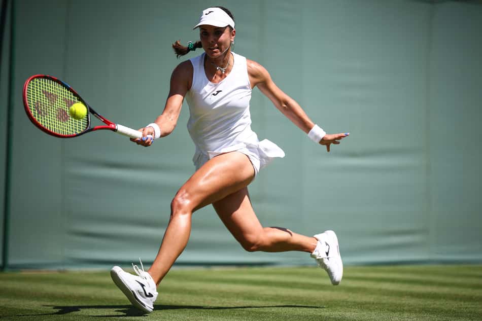 A búlgara Viktoriya Tomova devolve a bola contra a tunisiana Ons Jabeur em Wimbledon (Foto: HENRY NICHOLLS / AFP) / RESTRICTED TO EDITORIAL USE