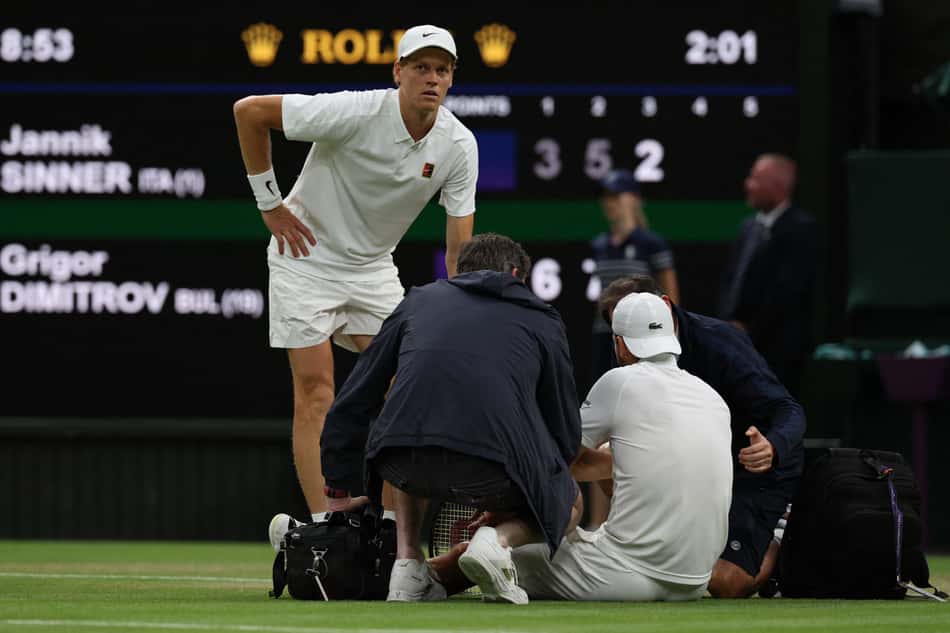 Búlgaro Grigor Dimitrov recebe tratamento médico antes de abandonar a partida contra Jannik Sinner em Wimbledon (foto: Adrian Dennis / AFP)