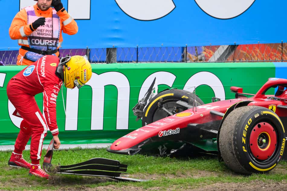 Ferrari's British driver Lewis Hamilton moves a piece of his front wing after crashing during the Formula One Dutch Grand Prix at The Circuit Zandvoort F1, western Netherlands, on August 31, 2025. (Photo by JOHN THYS / AFP)