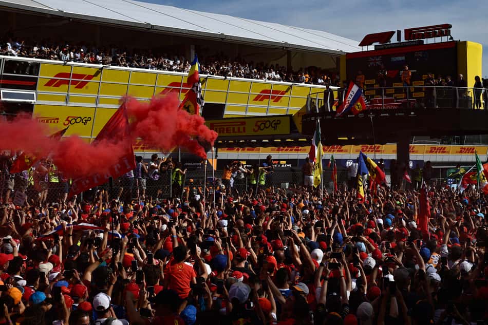 Spectators gather around the podium area on the track after the Italian Formula One Grand Prix at the Autodromo Nazionale Monza circuit, in Monza, northern Italy, on September 7, 2025. (Photo by Philippe Lopez / AFP)
