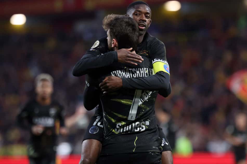 Paris Saint-Germain's Georgian forward #07 Khvicha Kvaratskhelia (front) is congratulated by Paris Saint-Germain's French forward #10 Ousmane Dembele after scoring a goal during the French L1 football match between RC Lens and Paris Saint-Germain (PSG) at the Stade Bollaert-Delelis stadium in Lens on May 13, 2026. (Photo by Francois LO PRESTI / AFP)