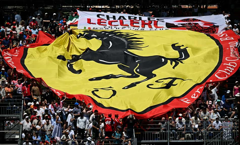 Torcedores da Ferrari vibram com uma bandeira gigante que exibe o logotipo da escuderia durante o primeiro treino livre no circuito de rua de Mônaco, antes do Grande Prêmio de Mônaco de Fórmula 1 (Foto: Gabriel Bouys / Afp)