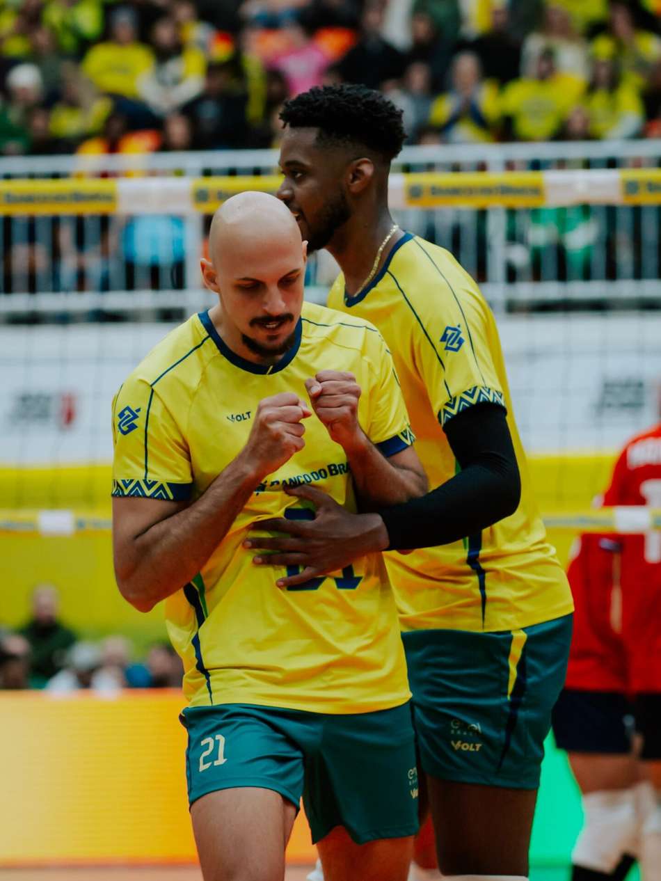 Guilherme Voss cerra os dois punhos, comemora ponto marcado pela Seleção Brasileira e é abraçado por Maicon