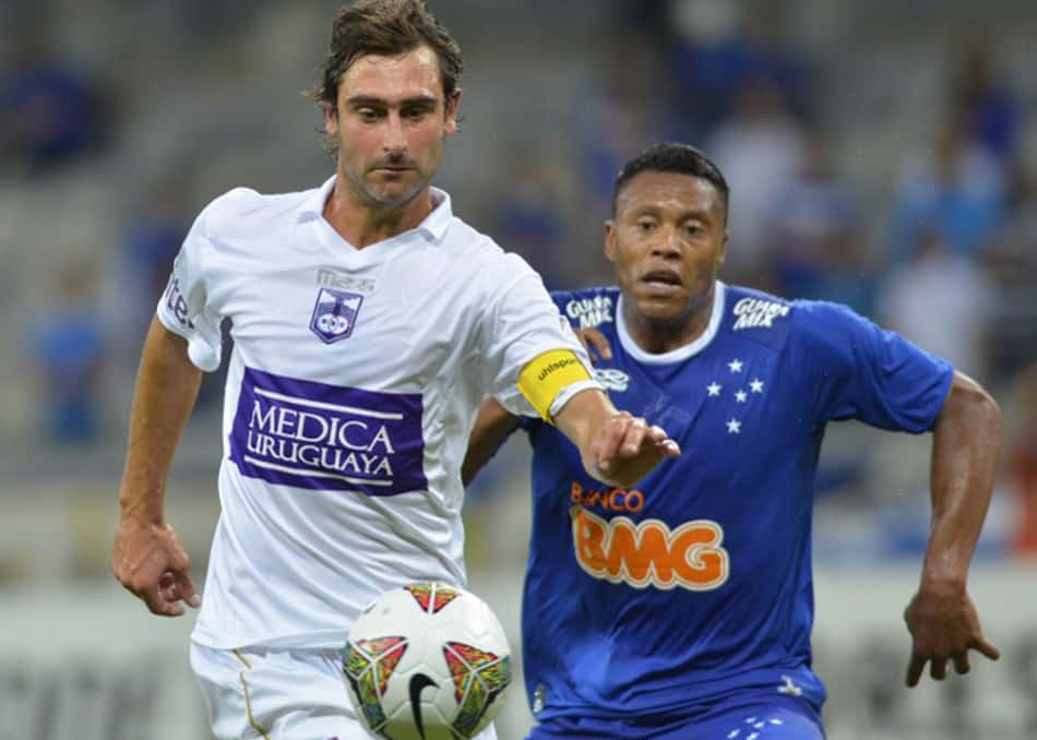 Júlio Baptista, do Cruzeiro, disputa a bola com zagueiro do Defensor