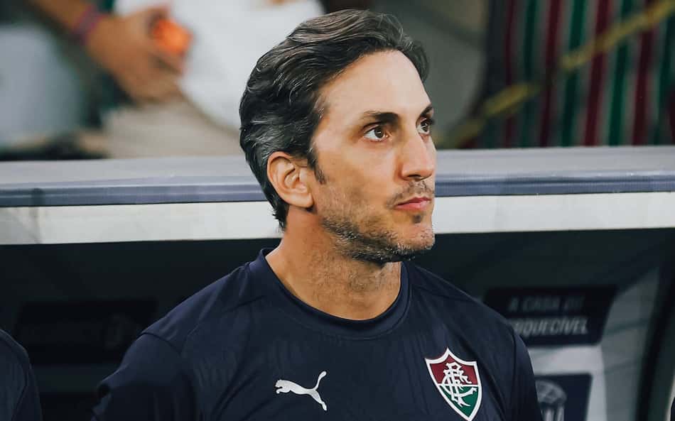 Luis Zubeldía em pé com braços para trás em frente ao banco do Fluminense em duelo com o Vasco