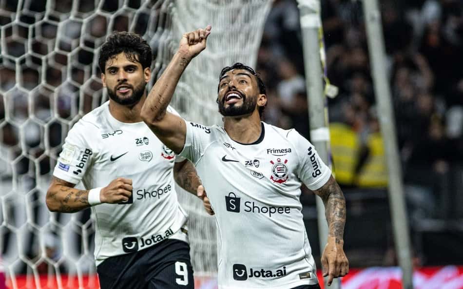 Bidu e Yuri, do Corinthians, celebram gol perto da baliza durante partida de futebol.