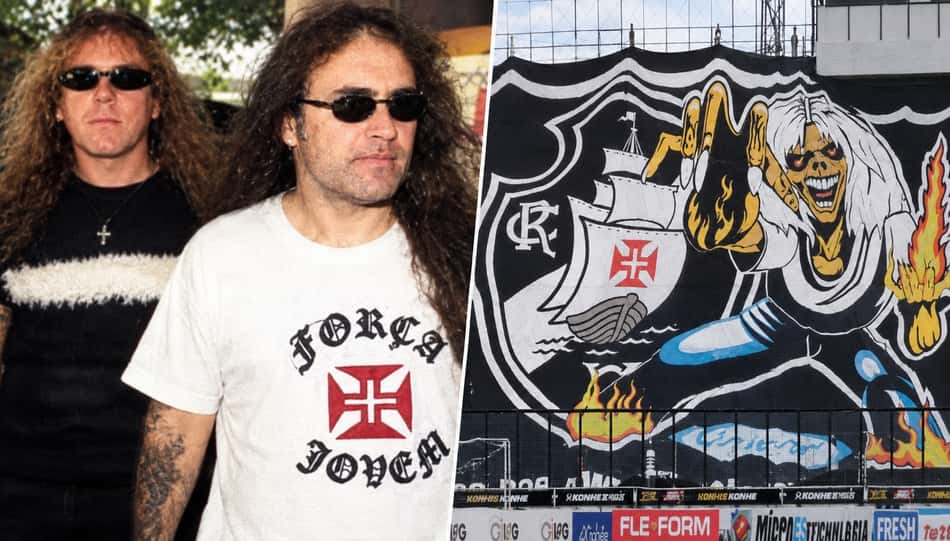 Dois homens usando camisetas da Força Jovem, torcedores do Vasco da Gama, ao lado de mural vascaíno com caveira, navio e fogo.