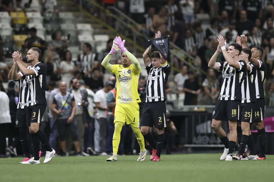 Atlético Mineiro contra Coritiba; goleiro em amarelo aplaude ao lado de seus companheiros em campo.