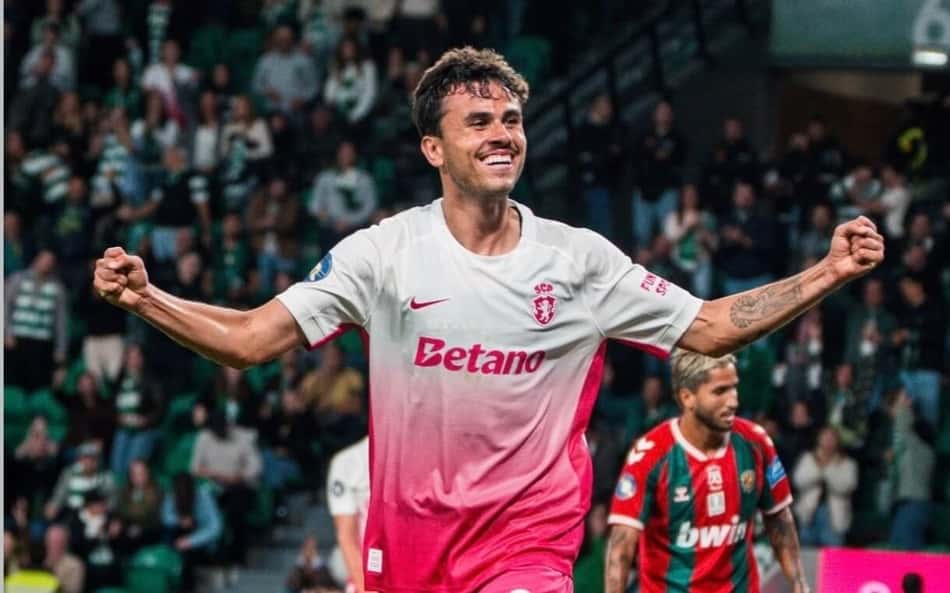 Pedro Lima, jogador do Sporting Portugal, celebra em campo; goleiro adversário no chão ao fundo.
