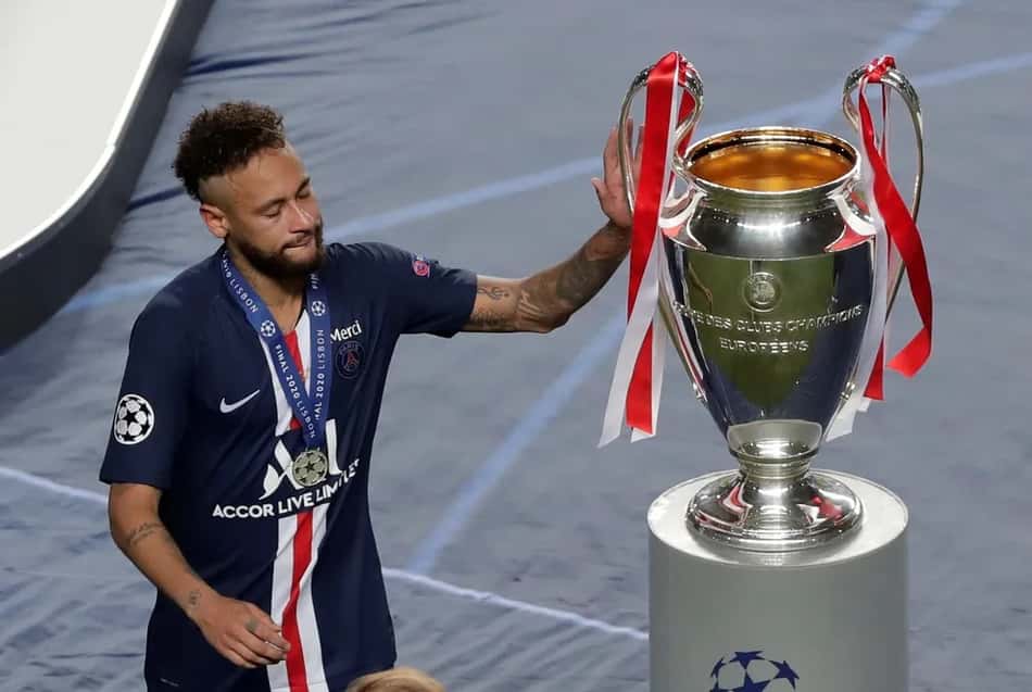 Neymar chorando, passando ao lado da taça da Liga dos Campeões, vencida pelo Bayern de Munique na final contra o PSG
